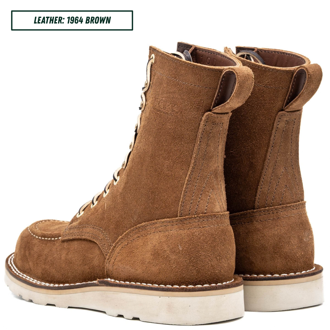A pair of brown suede lace-up ankle boots shown from the side and back on a white background, with a text label in the top left reading 'LEATHER: 1964 BROWN'.