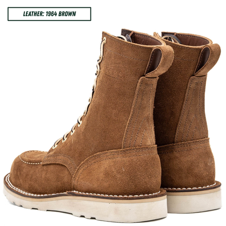 A pair of brown suede lace-up ankle boots shown from the side and back on a white background, with a text label in the top left reading 'LEATHER: 1964 BROWN'.