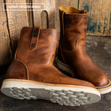 A pair of distressed brown leather mid-calf boots with yellow stitching, shown on a dark rustic surface with wooden planks in the background. A text overlay in the top left reads 'LEATHER: PREDATOR ORANGE'.