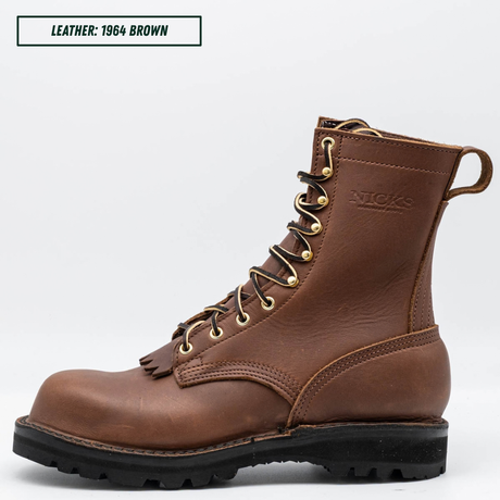 A brown leather lace-up work boot shown in profile against a light gray background, with a text label in the top-left corner reading 'LEATHER: 1964 BROWN'. The boot has gold-toned metal eyelets, a black lug sole, and an embossed 'NICKS' logo on the side.