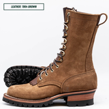 A brown suede lace-up work boot shown on a white background, with one boot standing upright and the other lying on its side to display the treaded sole. A text label in the top left reads 'LEATHER: 1964 BROWN'.