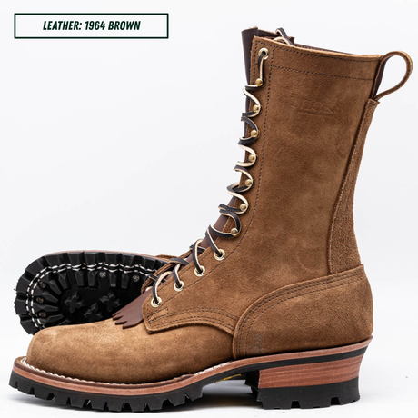 A brown suede lace-up work boot shown on a white background, with one boot standing upright and the other lying on its side to display the treaded sole. A text label in the top left reads 'LEATHER: 1964 BROWN'.