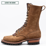 A brown suede lace-up work boot shown in profile against a white background, with a text label in the top-left corner reading 'LEATHER: 1964 BROWN'.