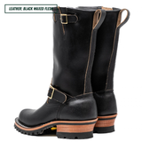 A pair of tall black leather boots with gold-tone buckle straps and stacked wood-look heels, shown on a white background with a text label in the top left corner.