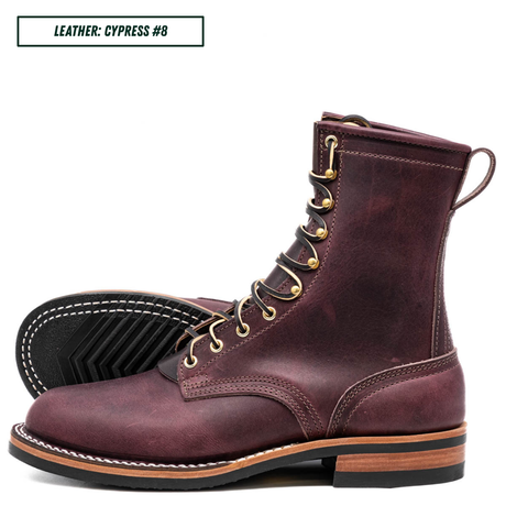 A pair of lace-up ankle boots in distressed plum cypress leather, shown on a white background with one boot standing upright and the other lying on its side to display the sole. A text label in the top left reads 'LEATHER: CYPRESS #8'.