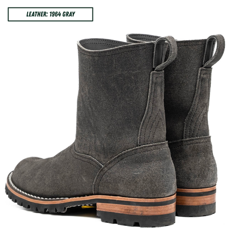 A pair of mid-calf boots in dark gray suede, shown from a three-quarter rear angle on a white background. A text label in the top-left corner reads 'LEATHER: 1964 GRAY'.