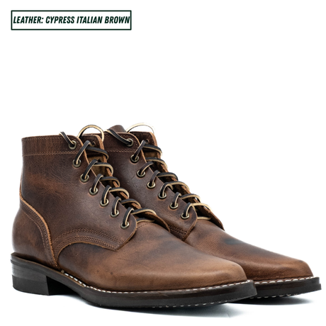 A pair of distressed leather lace-up ankle boots in a warm brown shade, shown against a plain white background with a text label in the top left corner reading 'LEATHER: CYPRESS ITALIAN BROWN'.