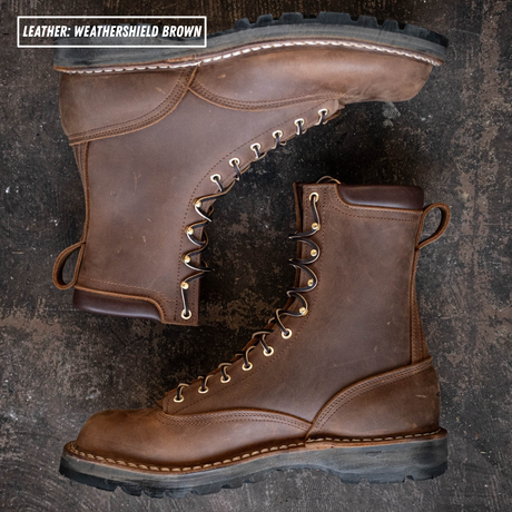 Weathershield brown lace to toe leather boots with padded collar. Both boots laying down on textures concrete. Label on top left stating "Leather: Weathershield Brown."