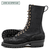 A pair of black leather lace-up boots with gold-tone eyelets and laces, shown on a white background with one boot standing upright and the other lying on its side to display the sole. A text label in the top-left corner reads 'LEATHER: MAX SUPPORT BLACK'.