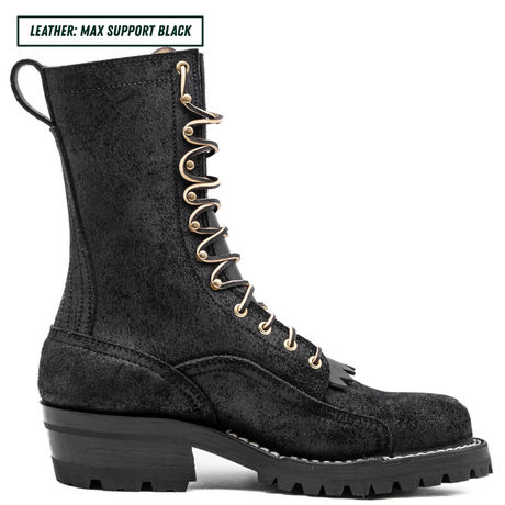 A black leather lace-up combat boot with gold-tone metal eyelets and a chunky black lug sole, shown in a side profile on a white background. A text label in the top-left corner reads 'LEATHER: MAX SUPPORT BLACK'.