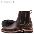 A dark brown leather Chelsea boot shown in side profile on a white background, with a second boot placed behind it to show the outsole. A small label in the top left reads 'LEATHER: CXL BROWN'.