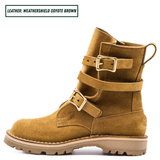 A pair of mid-calf boots in a warm coyote brown suede-like leather, featuring double buckle straps on the sides and a rugged lug sole. One boot is shown in profile.