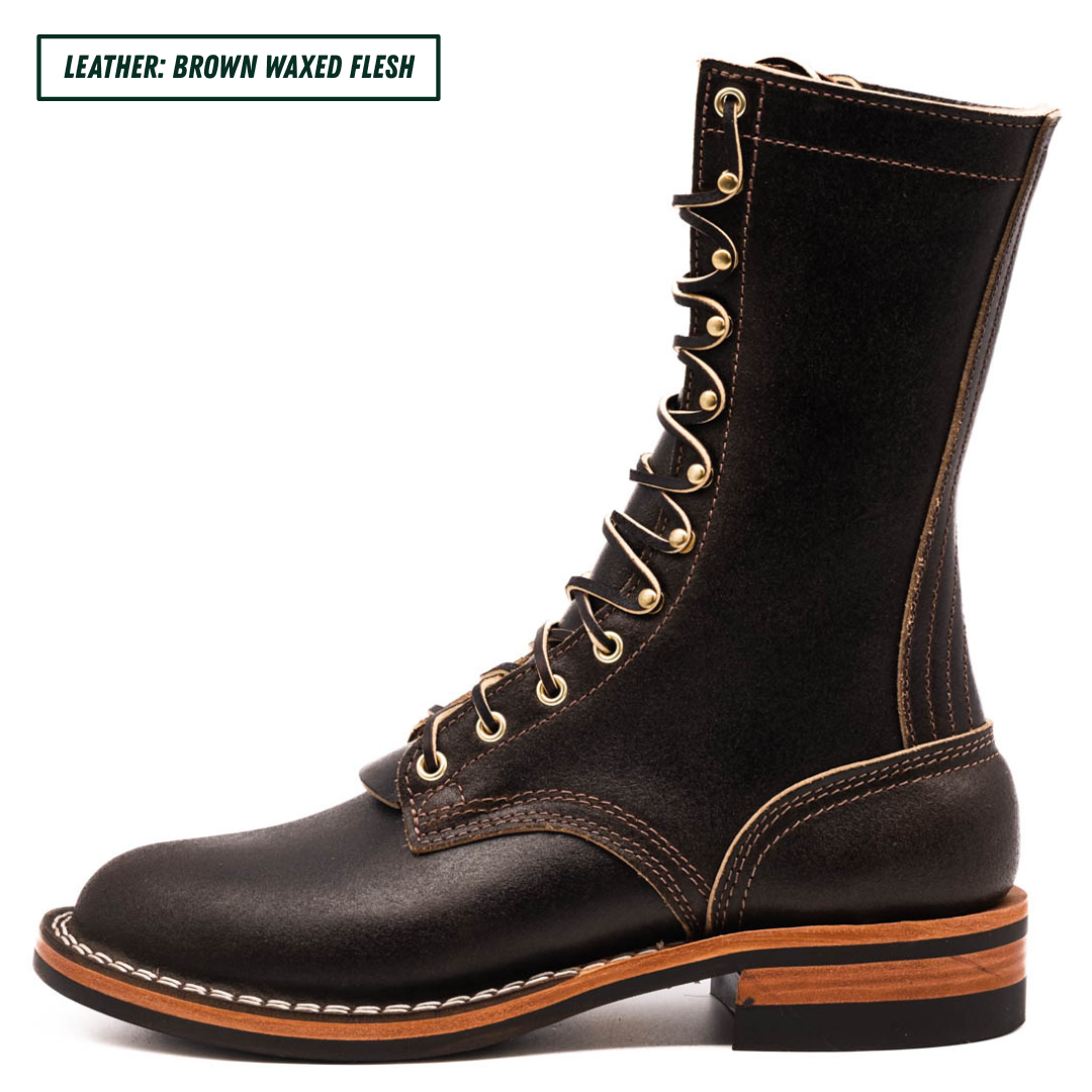 A dark brown leather lace-up boot with gold-tone eyelets, white contrast stitching, and a stacked sole, shown on a white background with a text label in the top-left corner.