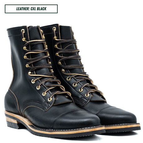 A pair of black leather lace-up boots with tan laces and brass eyelets, shown on a white background with a text label reading 'LEATHER: CXL BLACK'.