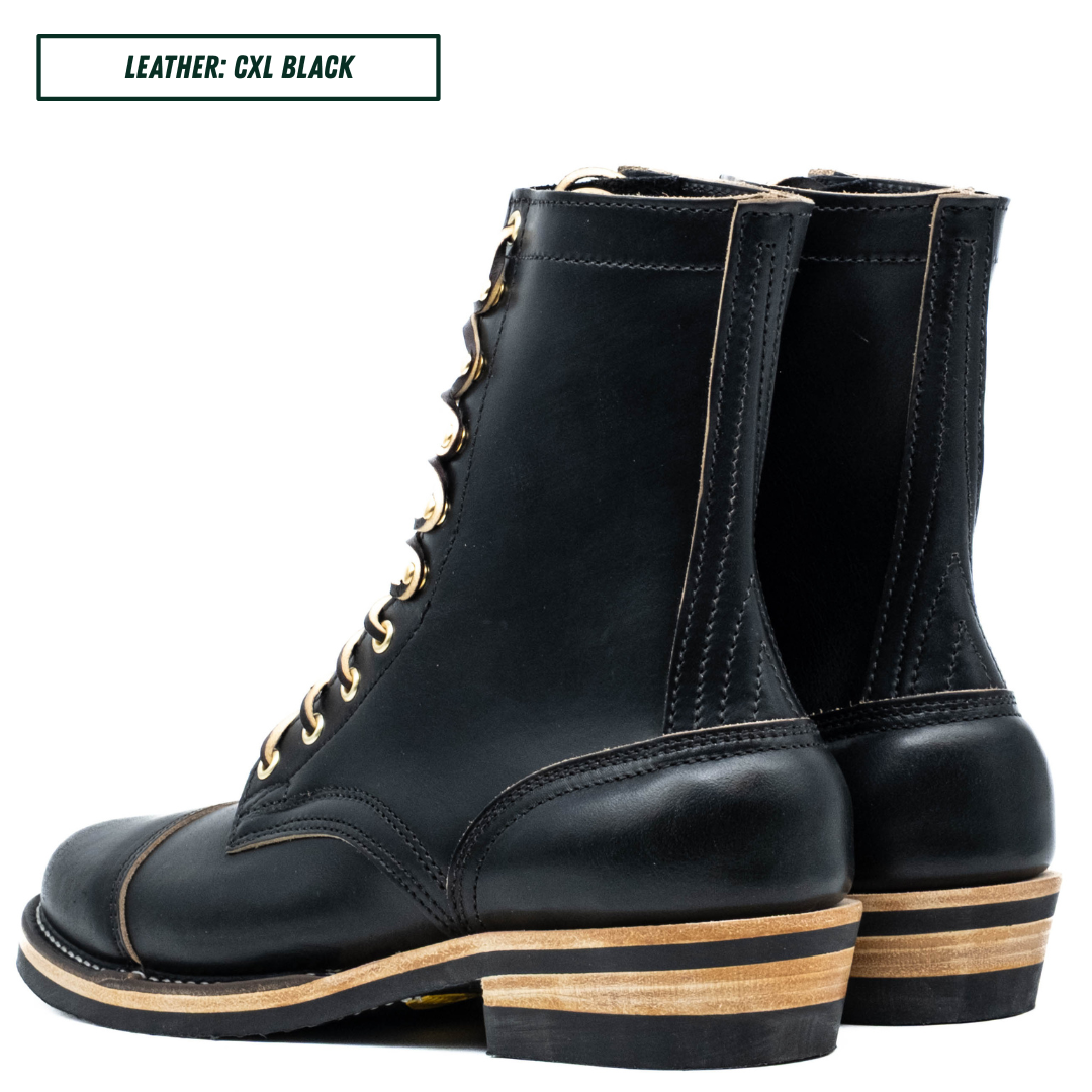 A pair of black leather lace-up ankle boots with gold-tone eyelets and a stacked wood-and-leather heel, shown on a white background with a text label in the top left corner.