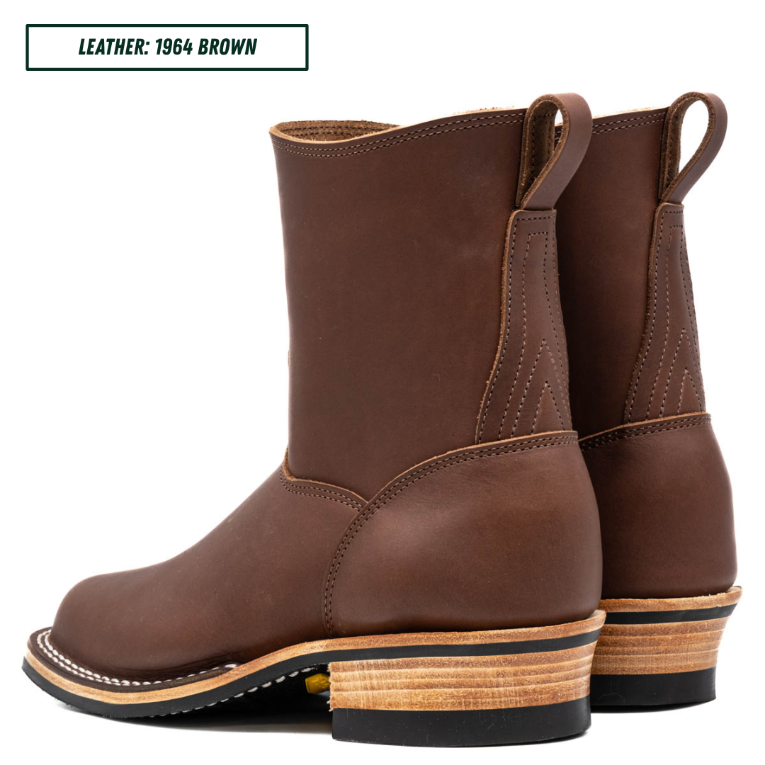 A pair of brown leather mid-calf boots with stacked wood-look heels, shown from a side angle on a white background. A text label in the top-left corner reads 'LEATHER: 1964 BROWN'.