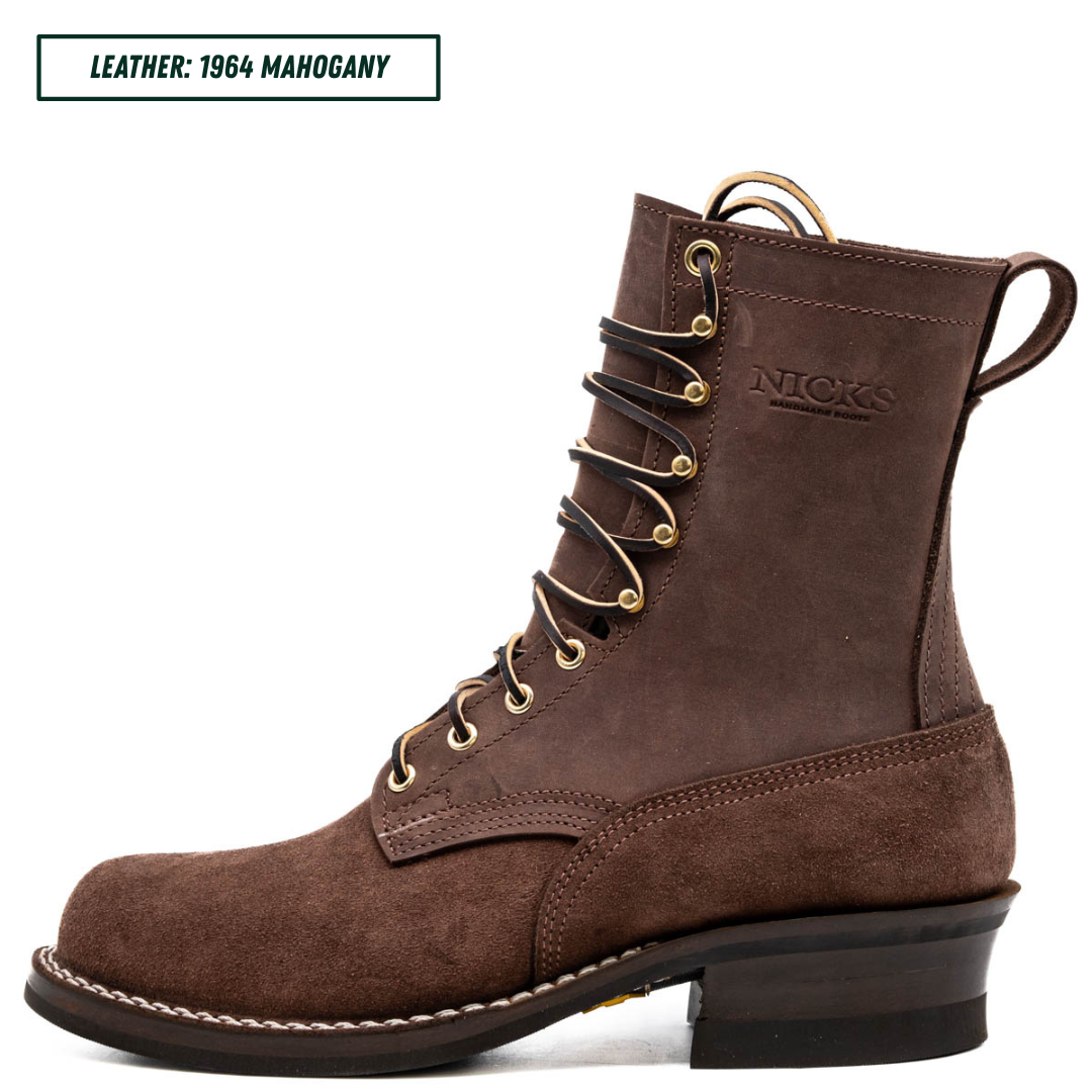 A dark brown suede lace-up boot shown in profile on a white background, with a text label in the top-left corner reading 'LEATHER: 1964 MAHOGANY'. The boot has gold-tone eyelets, white stitching, and the brand name 'NICKS' embossed on the side.