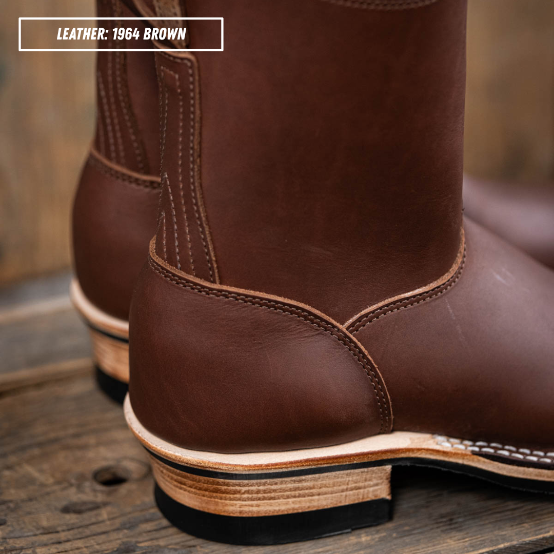 A close-up of a brown leather boot showing the heel, sole, and side stitching, with a text label in the top left that reads 'LEATHER: 1964 BROWN'.