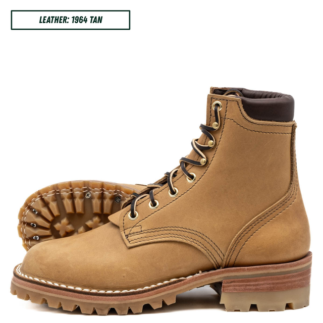 A tan leather lace-up boot shown in a clean studio product shot, with the sole turned up to display the tread pattern. A small text label in the top left reads 'LEATHER: 1964 TAN'.