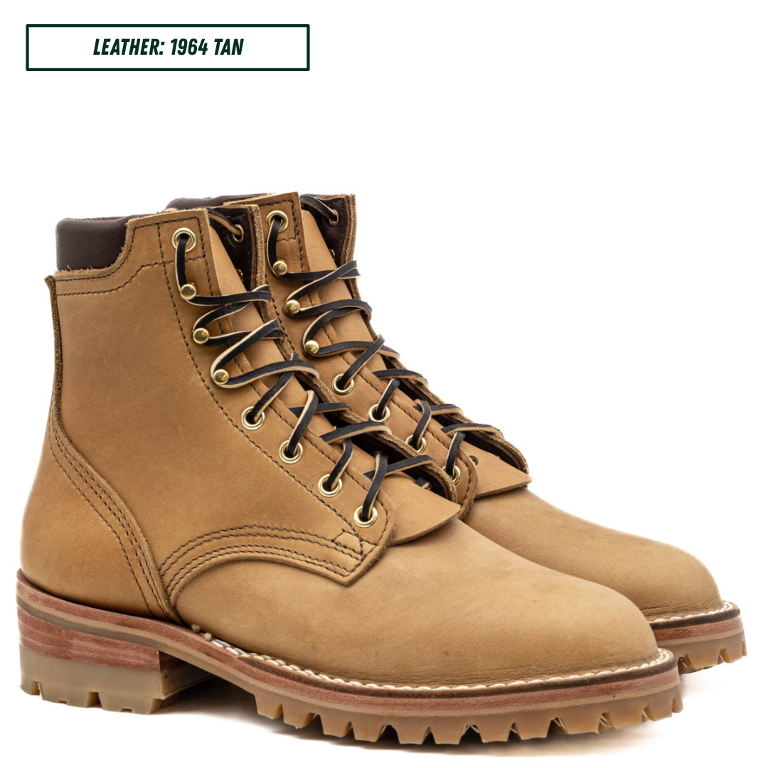 A pair of tan leather lace-up work boots shown on a white background, with a text label in the top left that reads 'LEATHER: 1964 TAN'.
