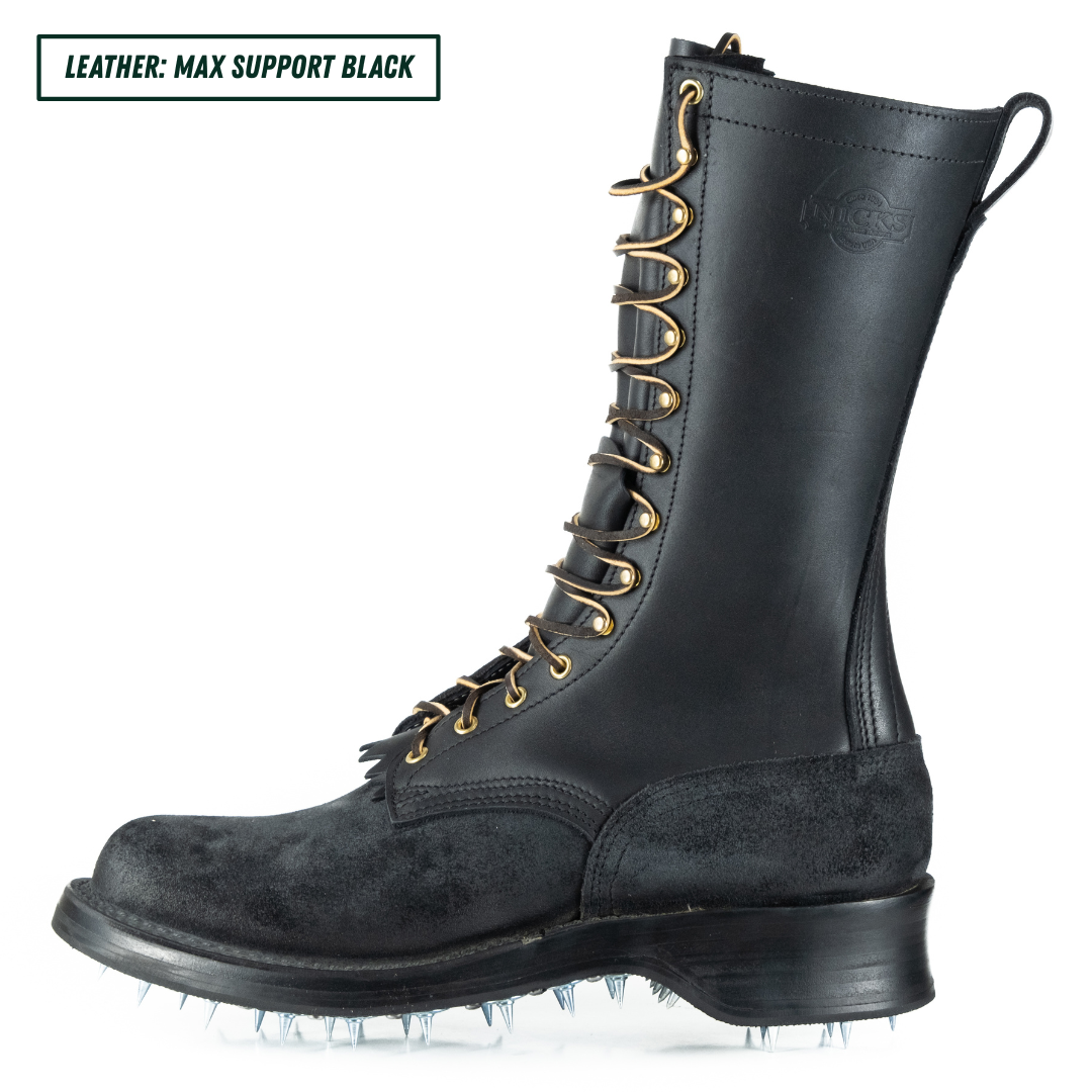 A black leather work boot with gold-tone laces and metal eyelets, shown in profile on a white background. A text label in the top-left corner reads 'LEATHER: MAX SUPPORT BLACK'.
