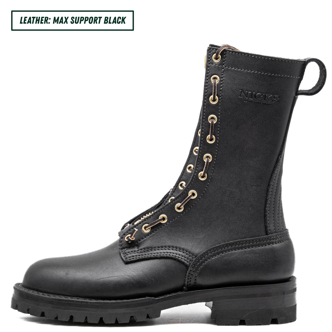 A black leather lace-up ankle boot shown in profile on a white background, with a small text label in the top-left corner reading 'LEATHER: MAX SUPPORT BLACK'. The boot has gold-tone eyelets, a pull tab, and the brand name 'NICKS' embossed on the side.