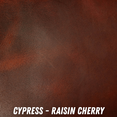 A close-up texture swatch of dark reddish-brown leather with white text at the bottom reading 'CYPRESS - RAISIN CHERRY'.