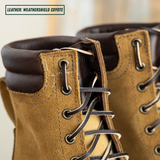 Close-up of a pair of lace-up boots in textured coyote brown leather, showing the laces, eyelets, collar, and interior lining. A small label in the top left reads 'LEATHER: WEATHERSHIELD COYOTE'.