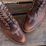 A brown leather packer boot with toe bug detailing. Text label in the top-left corner that reads 'LEATHER: PREDATOR ORANGE'.