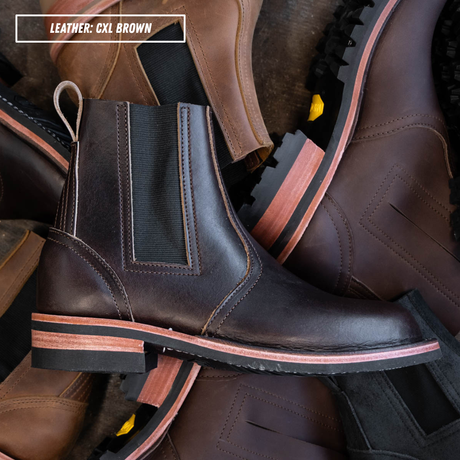 A pair of dark brown leather Chelsea boots with black elastic side panels and a layered sole featuring a light wood stripe, arranged in a pile with a text overlay that reads 'LEATHER: CXL BROWN'.