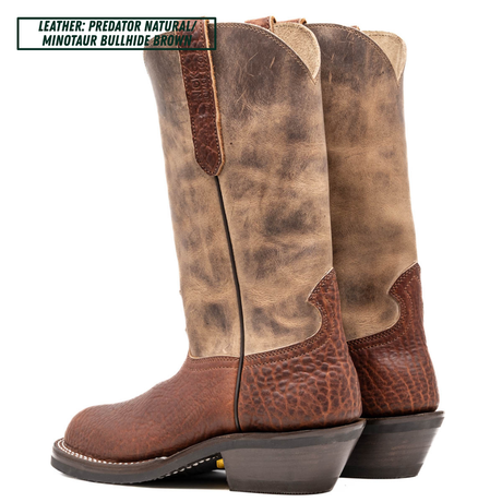 A pair of tall western cowboy boots shown from the side on a white background, with a text label in the top left reading 'LEATHER: PREDATOR NATURAL MINOTAUR BULLHIDE BROWN'. The boots have a distressed tan and brown leather shaft with a darker brown textured leather lower section and heel.