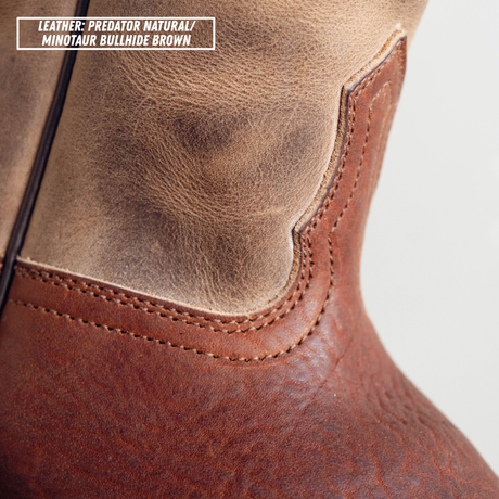 Close-up of a leather boot showing two shades of brown leather: a lighter tan natural leather at the top and a darker brown bullhide brown leather at the bottom, with a text label in the top-left corner reading 'LEATHER: PREDATOR NATURAL / MINOTAUR BULLHIDE BROWN'.
