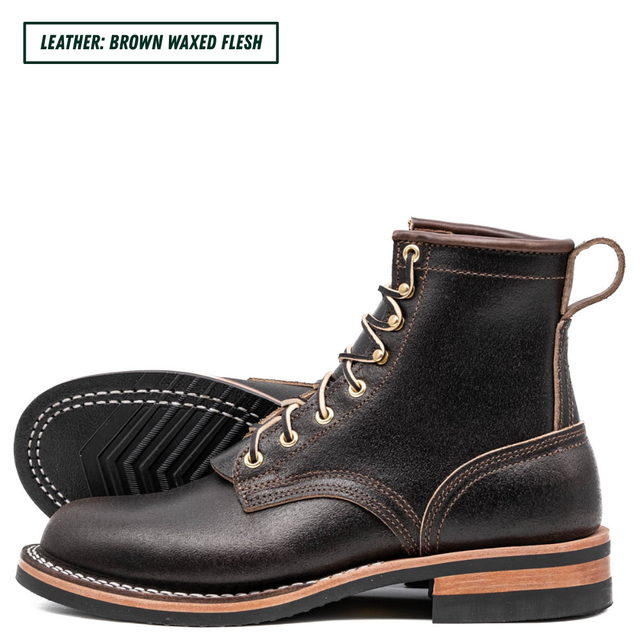 A pair of dark brown waxed leather lace-up boots shown on a white background, with a text label in the top-left corner reading 'LEATHER: BROWN WAXED FLESH'. The boots feature gold-tone eyelets, contrast stitching, and a stacked sole with a tan mid-layer.