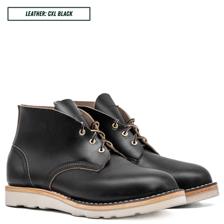 A pair of black leather lace-up ankle boots with light tan soles, shown on a white background with a text label in the top left that reads 'LEATHER: CXL BLACK'.