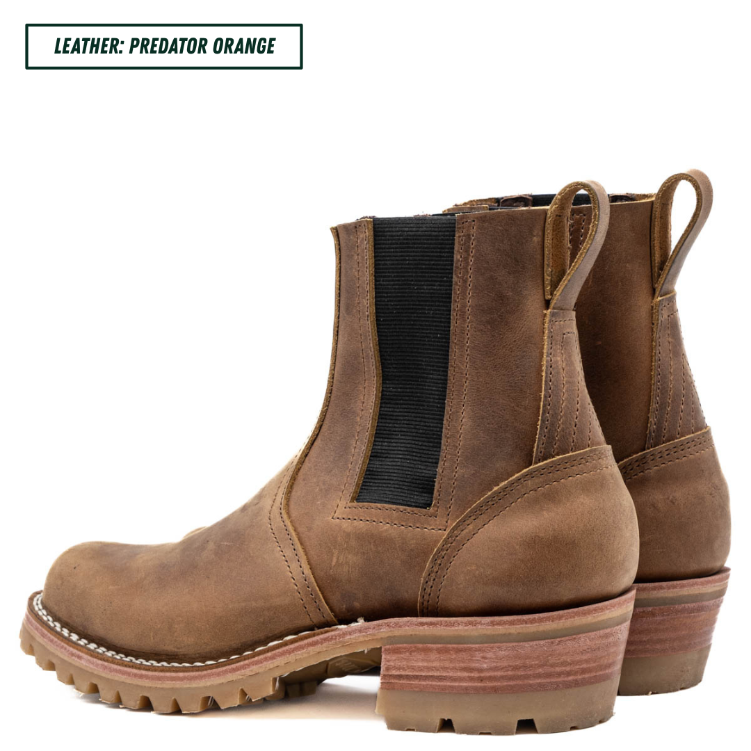 A pair of brown leather Chelsea-style ankle boots with black elastic side panels and pull tabs, shown on a white background with a text label reading 'LEATHER: PREDATOR ORANGE'.