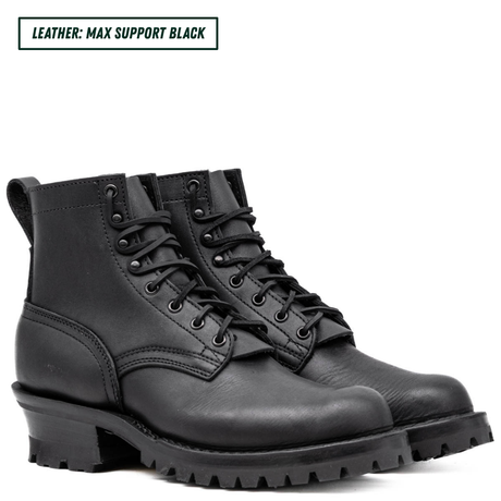 Black leather boots with thick soles on a white background