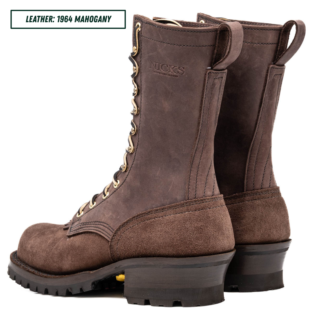 A pair of brown suede and leather lace-up boots shown on a white background, with a text label in the top-left corner reading 'LEATHER: 1964 MAHOGANY'. The brand name 'NICKS' is embossed on the side of the boot.