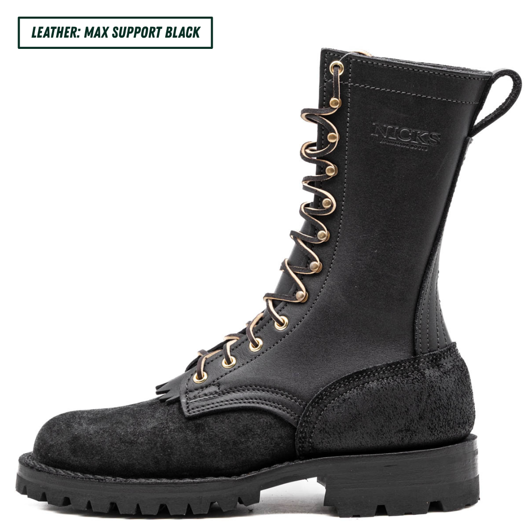 A black leather and suede work boot with gold-tone eyelets and laces, shown in a side profile on a white background. A text overlay in the top-left corner reads 'LEATHER: MAX SUPPORT BLACK'.