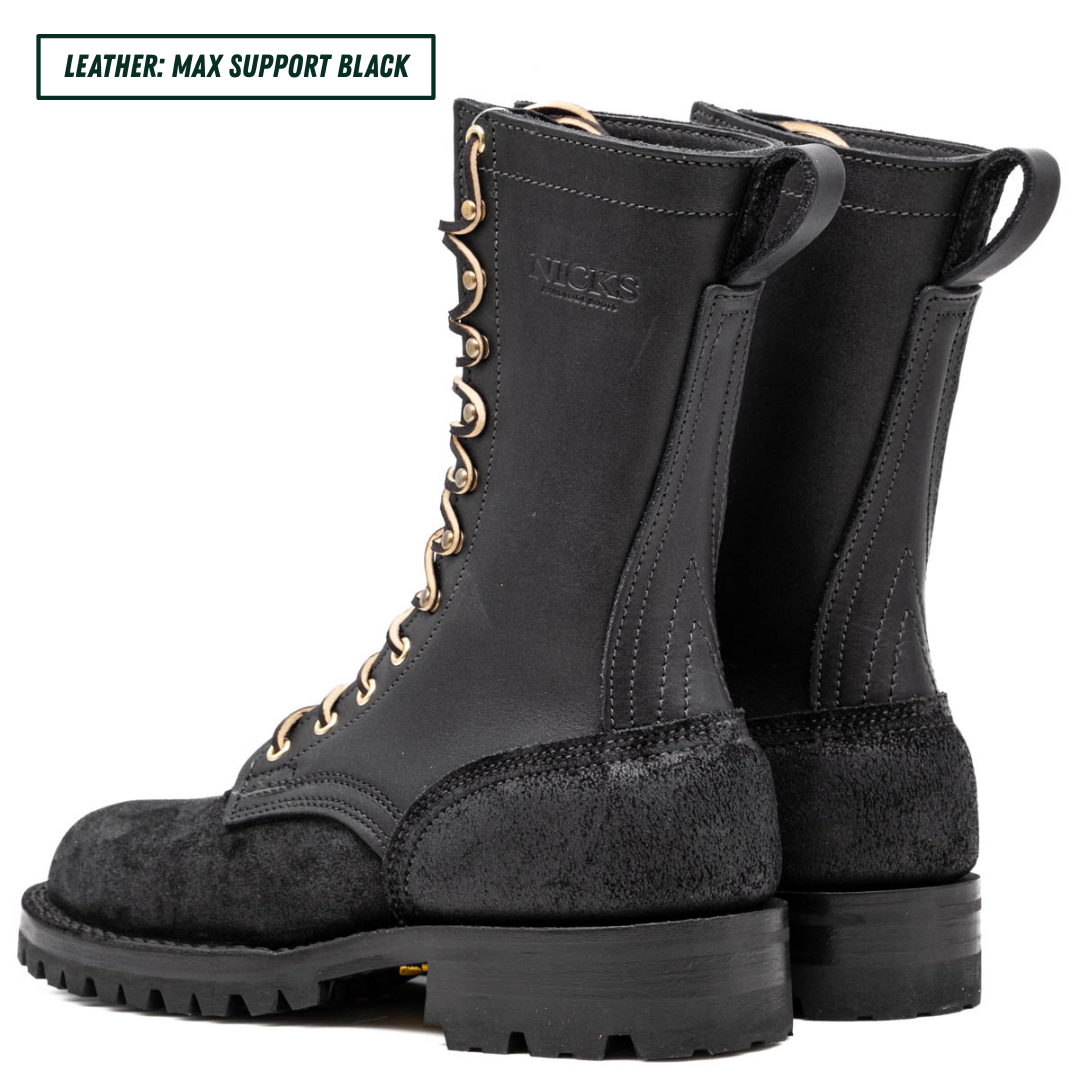 A pair of black leather lace-up boots shown from the side and back on a white background, with a text label in the top-left corner that reads 'LEATHER: MAX SUPPORT BLACK'. The brand name 'NICKS' is embossed on the side of the boot shaft.