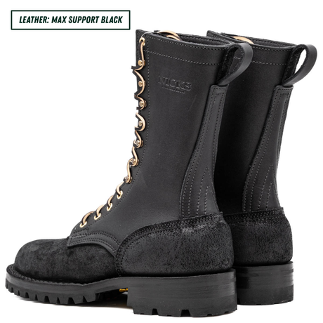 A pair of black leather lace-up boots shown from the side and back on a white background, with a text label in the top-left corner that reads 'LEATHER: MAX SUPPORT BLACK'. The brand name 'NICKS' is embossed on the side of the boot shaft.