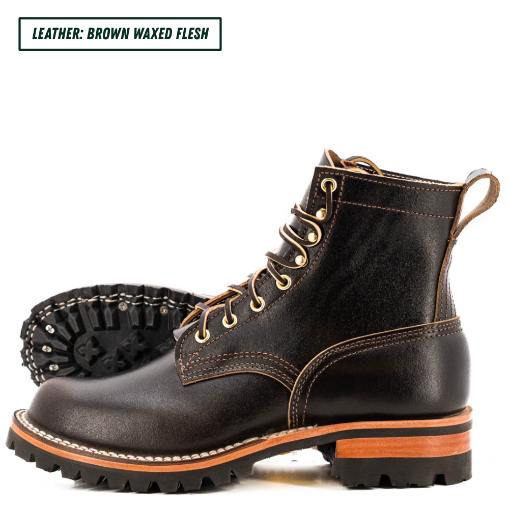 A pair of dark brown waxed leather lace-up boots shown on a white background, with one boot standing upright and the other lying on its side to display the treaded sole. A text label in the top left reads 'LEATHER: BROWN WAXED FLESH'.