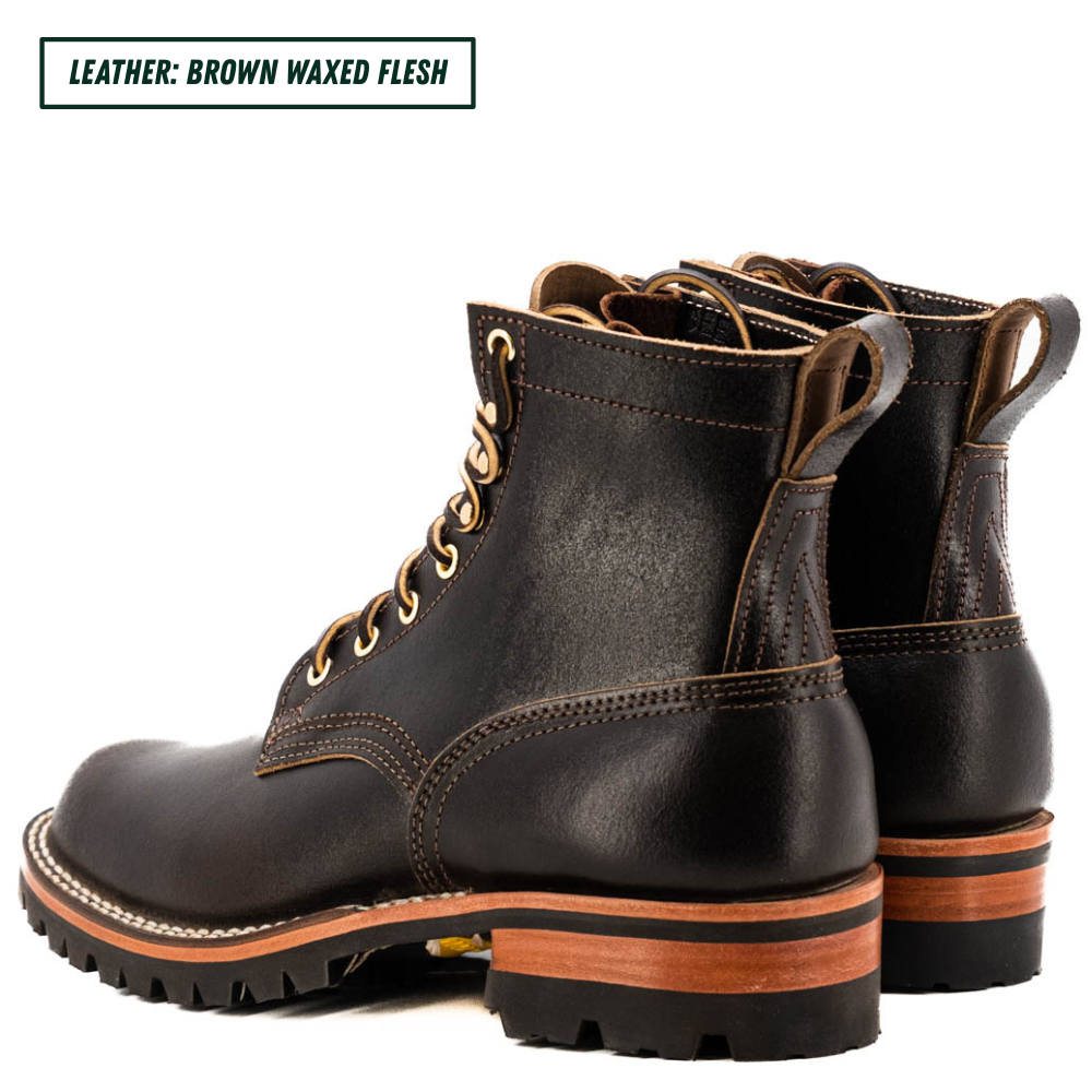A pair of brown waxed leather lace-up work boots shown from a three-quarter angle on a white background, with a text label in the top-left corner reading 'LEATHER: BROWN WAXED FLESH'.
