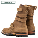 A pair of mid-calf leather boots in tan, featuring multiple decorative straps with brass buckles and pull tabs on the sides, set against a plain white background with a text label in the top left corner.