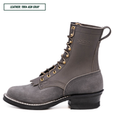 A single dark gray leather lace-up boot shown in side profile on a white background, with a small text label in the top-left corner reading 'LEATHER: 1964 ASH GRAY'. The boot has gold-tone eyelets and laces, white contrast stitching, a low black heel, and a pull tab at the back.