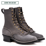 A pair of dark gray leather lace-up boots with gold-tone eyelets and laces, shown on a white background with a text label at the top reading 'LEATHER: 1964 ASH GRAY'.