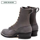 A pair of dark gray leather lace-up boots shown from the side and back on a white background, with a text label in the top-left corner reading 'LEATHER: 1964 ASH GRAY'.