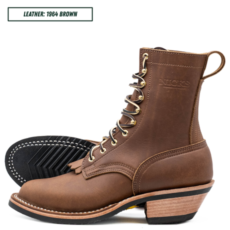 A brown leather lace-up boot shown in side profile with a second boot turned to show the black treaded sole. The brand name 'NICKS' is embossed on the side, and a text label in the top left reads 'LEATHER: 1964 BROWN'.