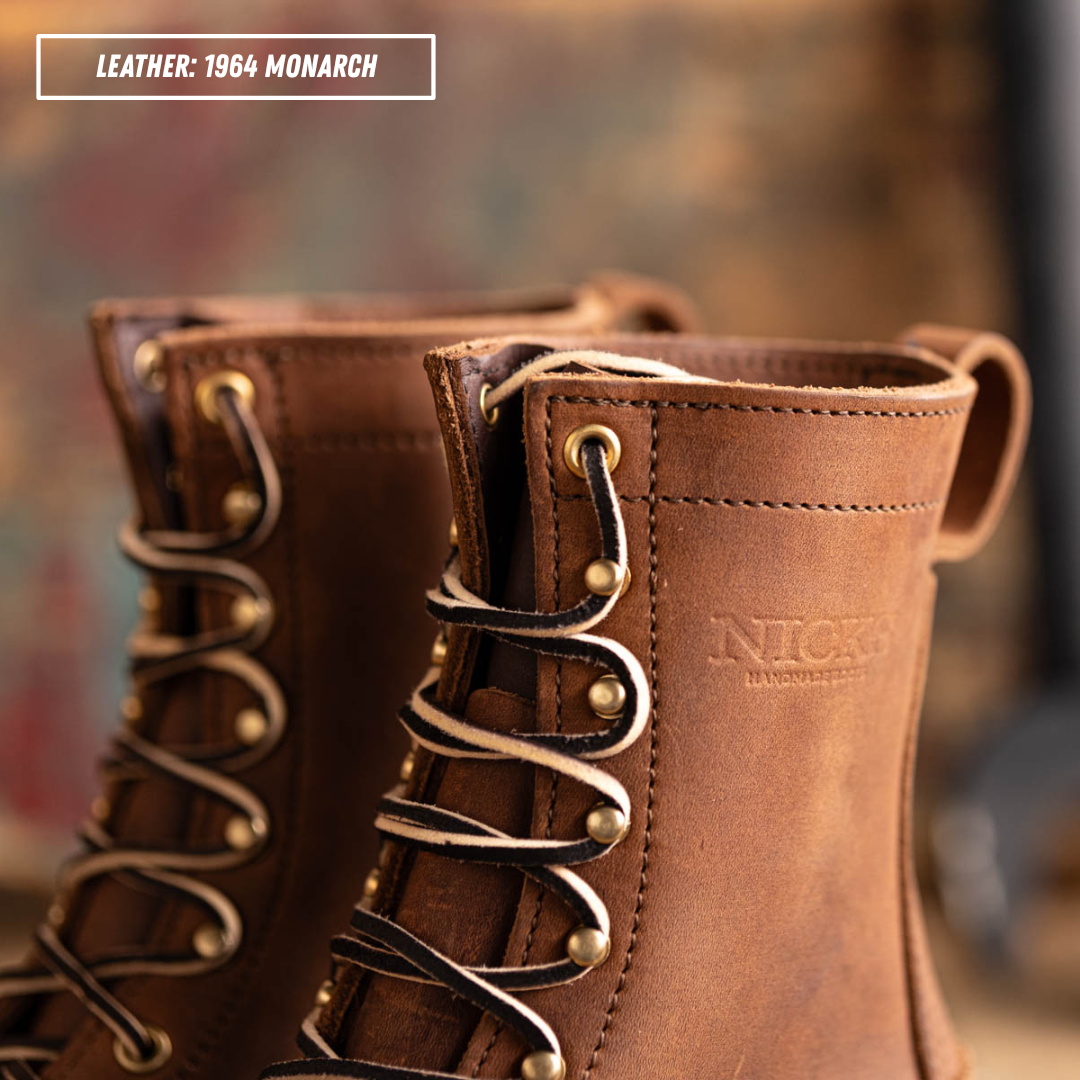 Close-up of a pair of brown leather lace-up boots with brass eyelets and laces, featuring an embossed 'NICKS HANDMADE BOOTS' logo on the side. A text label in the top left reads 'LEATHER: 1964 MONARCH'.