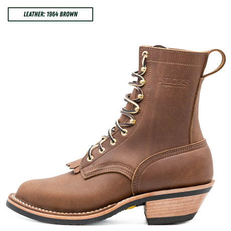 A brown leather lace-up ankle boot shown in side profile on a white background, with a small text label in the top-left corner reading 'LEATHER: 1964 BROWN'. The boot has gold-tone eyelets, a stacked wood-look heel, and the brand name 'NICKS' embossed on the side.