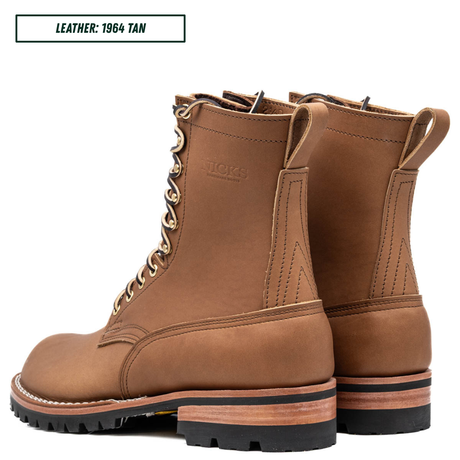 HD lace up build your own boots sitting together facing back left. Top reads 'LEATHER; 1964 TAN'.